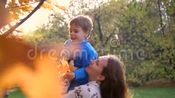一个妈妈和一个孩子玩把他抱在怀里吐了出来阳光透过孩子他的笑声和欢乐视频的预览图