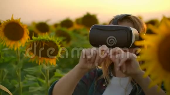 女农民经理在大自然的夏天晚上戴着VR眼镜工作视频的预览图