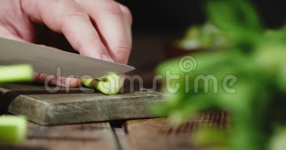 男人手在切菜板上切鲜芹菜视频的预览图