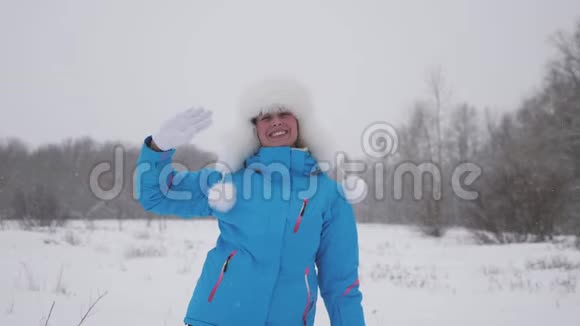 快乐的女孩在一个滑雪胜地挥手微笑圣诞节假期漂亮的女模特儿热情洋溢视频的预览图