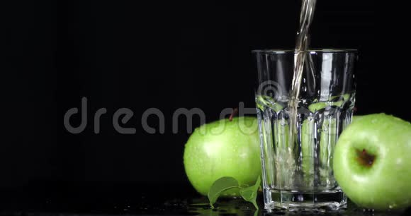 把青苹果的鲜汁倒入玻璃杯中视频的预览图
