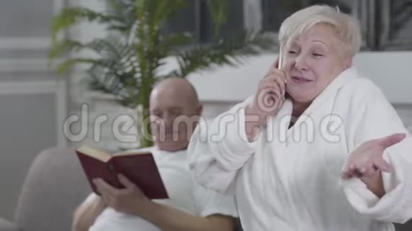 积极的老白种人女人棕色的眼睛和金发在前台打电话愤怒的丈夫视频的预览图