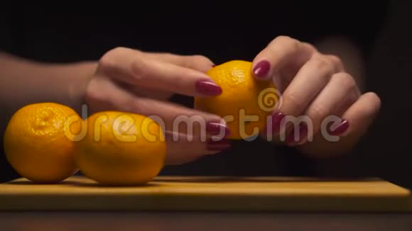 在现代化的厨房里女人手的特写可以在木板上净化橘子健康的饮食视频的预览图