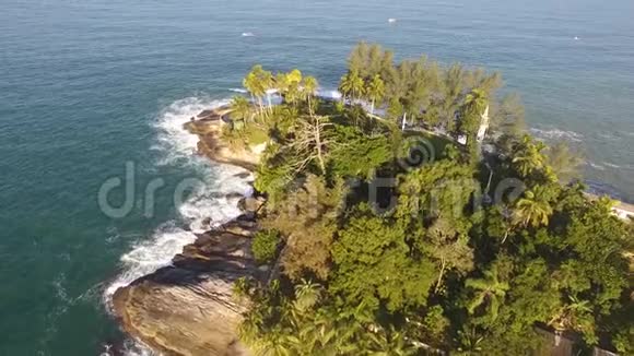 飞越美丽的热带岛屿波浪撞击岩石海绿在阳光明媚的一天视频的预览图