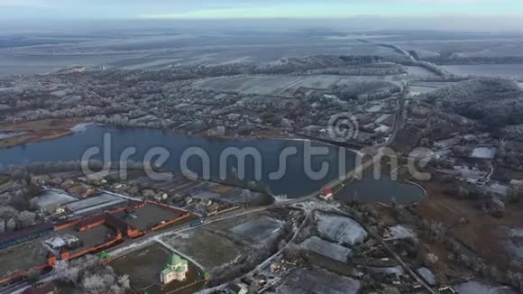 冬天在寒冷的雪天飞越村庄视频的预览图