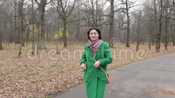 中年白种人妇女在公园前景镜头中沿着小路行走视频的预览图