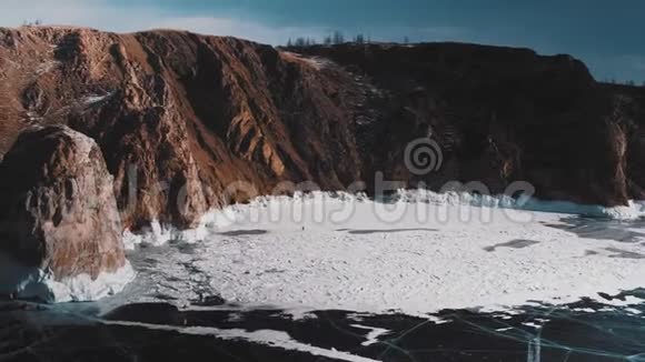 冰封的贝加尔湖和岩石岛深裂缝的蓝色冰视频的预览图