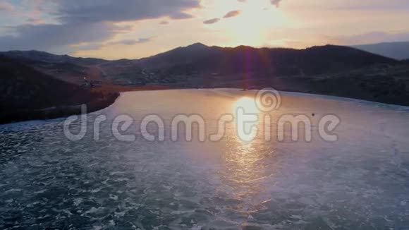 日落于冰冻的贝加尔湖冬季景观冰清玉洁鸟瞰视频的预览图