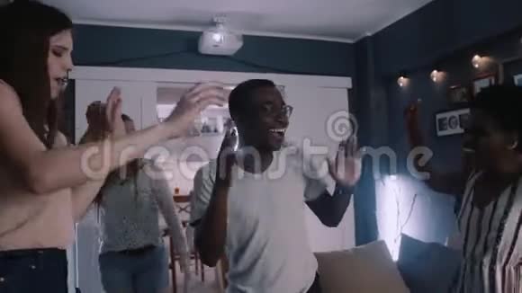 开朗年轻英俊快乐的非裔美国学生男子与朋友在度假聚会上跳舞慢动作视频的预览图