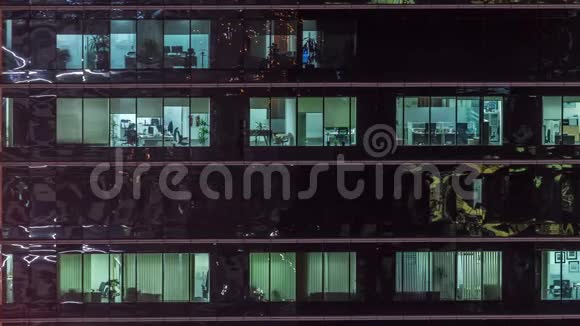 办公室摩天大楼在深夜外景室内灯光亮着人们在夜间工作视频的预览图