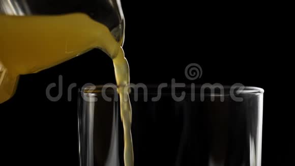 在背景下用一个高玻璃杯缓慢地倒入新鲜橙汁视频的预览图