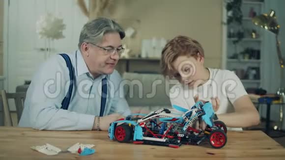 一辆玩具车由一个男孩和他爷爷完成视频的预览图