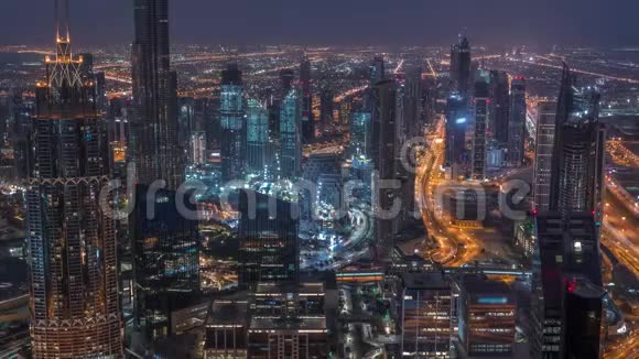 迪拜市中心天际线未来主义城市景观与许多摩天大楼和BurjKhalifa空中夜晚到白天视频的预览图