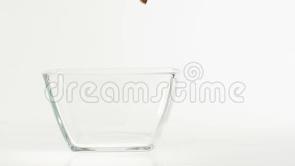 新鲜健康食品巧克力谷类食品垫落在一个透明的方形碗白色背景早餐的概念视频的预览图