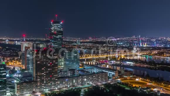 在维也纳城市的空中全景中摩天大楼历史建筑和河边长廊在夜间消失视频的预览图