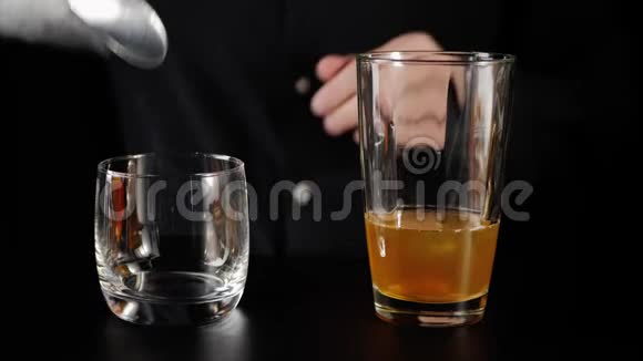 威士忌酸鸡尾酒酒保拿了一勺从桶里拿了一些冰把冰块倒在岩石玻璃里国际律师协会官方视频的预览图