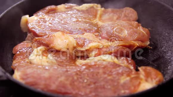 为了在锅里煮一块肉那人在锅里放了一块生的红猪肉一个铸铁煎锅视频的预览图