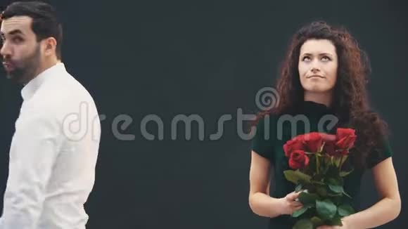 可爱古怪的女人给男人戒指和玫瑰并迫使他提出她的建议他不想这么做视频的预览图