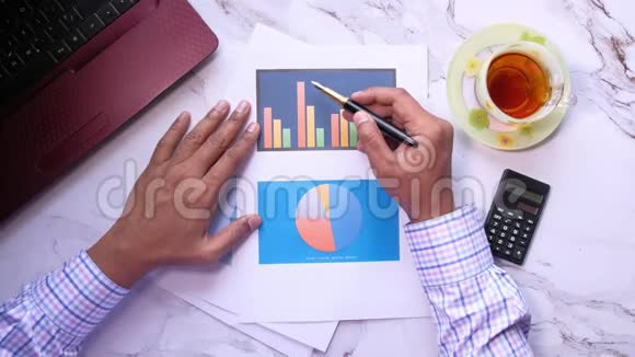 人手分析办公桌财务图表视频的预览图