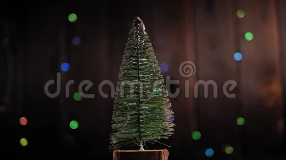 圣诞树慢慢地在木制背景上旋转闪烁着灯光视频的预览图