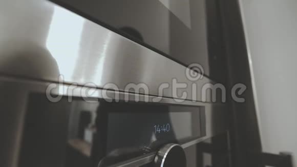 新家现代微波炉和烤箱在厨房切换程序和打开加热烹饪特写广角直到视频的预览图