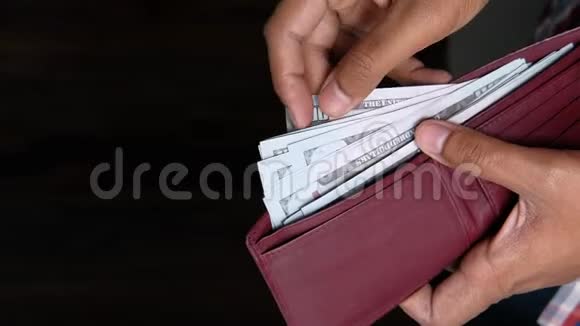 商人手里拿着钱包数美元钞票视频的预览图