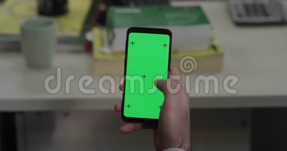 手持手机带绿色屏幕显示视频的预览图