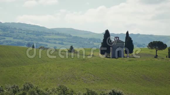 在托斯卡纳中心的皮恩扎附近有着绿色起伏的山丘和著名的维塔塔教堂令人惊叹的春天景观视频的预览图