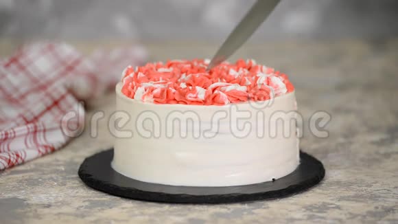 刀切了一块美味的樱桃蛋糕上面有粉色奶油视频的预览图