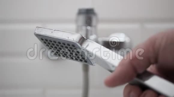 男子在浴室开放水和使用淋浴头视频的预览图