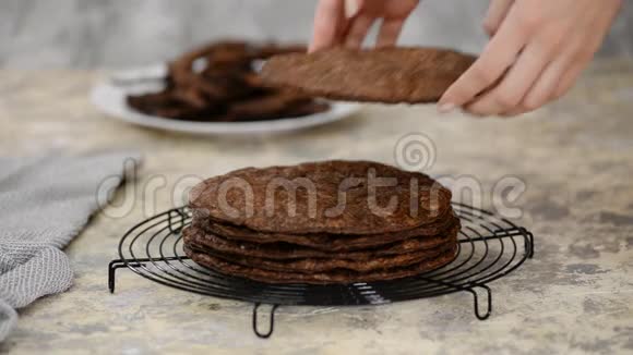 新鲜烘焙的圆形膨化糕点层自制传统巧克力拿破仑蛋糕冷却架视频的预览图