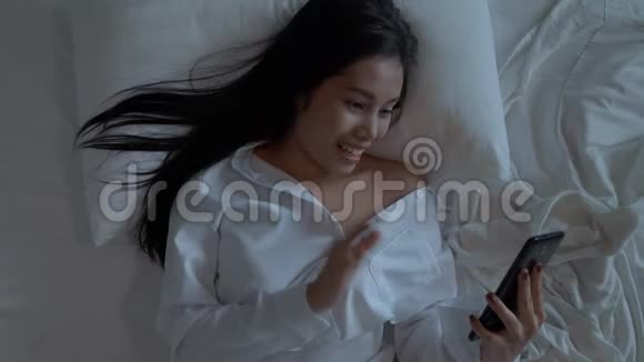 亚洲女性使用手机视频电话与恋人聊天挥手问候聊天和挥手告别视频的预览图