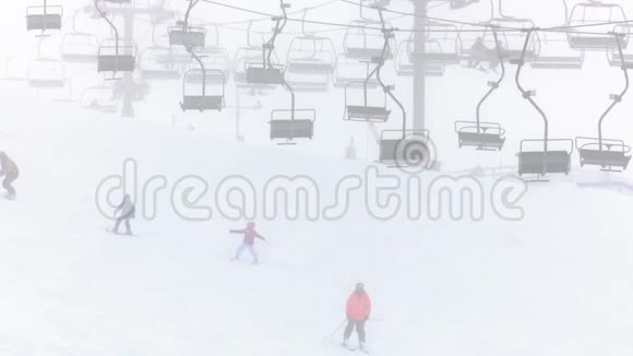 儿童和成人在雾和雪中享受一天的滑雪和雪视频的预览图