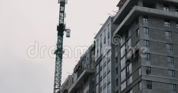公寓楼在建用高吊车建筑工人造房子建筑工地上的高吊车视频的预览图