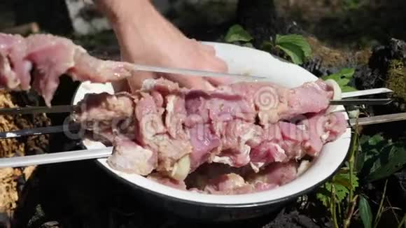 主厨把肉粘在肉串上洋葱腌肉户外烧烤烧烤炉煮肉视频的预览图