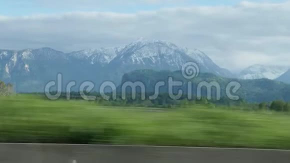 美丽的雪山从汽车室内观汽车沿着瑞士山脉行驶雪山背景视频的预览图