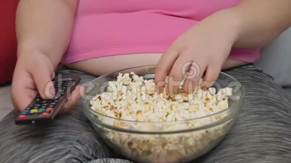 胖女人坐在沙发上吃爆米花视频的预览图