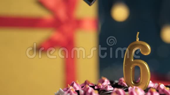 生日蛋糕6号金烛用打火机点燃蓝色背景礼品黄盒用红丝带绑好关闭视频的预览图