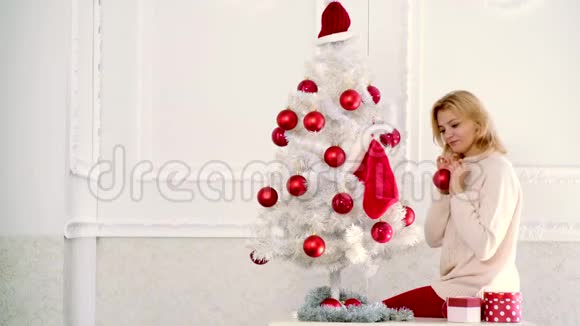 圣诞快乐新年快乐女孩装饰圣诞树穿着圣诞礼服性感女孩视频的预览图