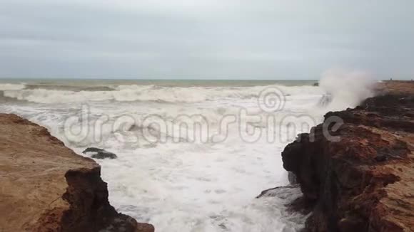 暴风雨的大海海浪拍打着海岸上的岩石视频的预览图