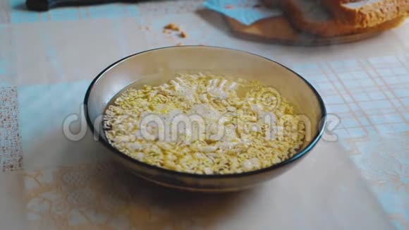美味的方便面碗在桌子上特写倒入沸水视频的预览图