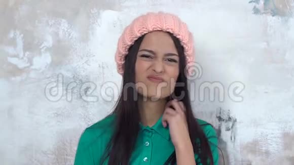 年轻女子独自一人戴着白帽子指着喉咙不开心的问题视频的预览图