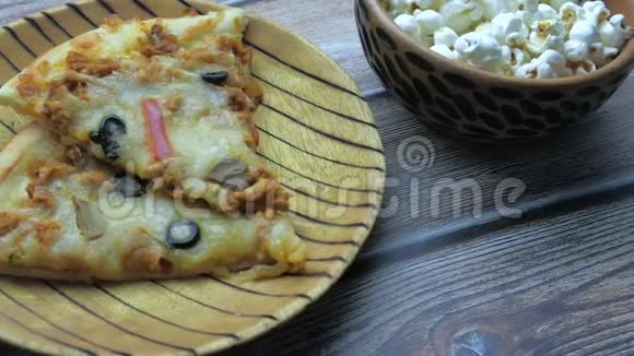 快餐和不健康的饮食观念桌上放披萨和爆米花视频的预览图