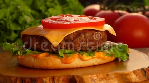 番茄片落在切达干酪上放在半熟的芝士汉堡上视频的预览图