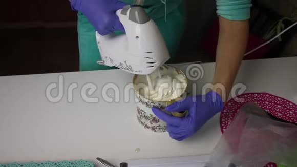 女人用搅拌机把棉花糖和琼脂糖浆混合在容器里视频的预览图