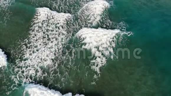 波浪飞溅运动的飞行鸟瞰渐变绿松石蓝海水视频的预览图