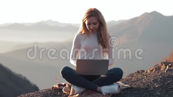 女性在笔记本电脑上工作拥有美丽的山景视频的预览图