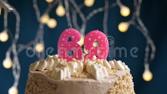 生日蛋糕有69个数字由较轻的粉红色蜡烛燃烧在蓝色的背景上蜡烛被点燃了慢动作视频的预览图