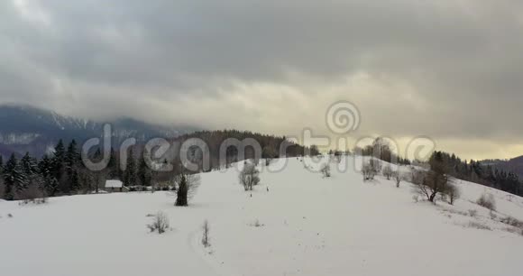 覆盖着雪景的森林山村鸟瞰图视频的预览图