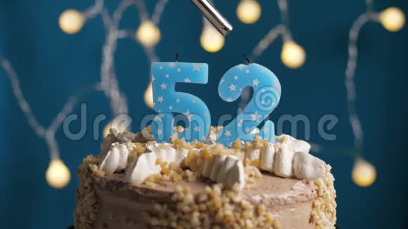 生日蛋糕蓝色背景上有52支蜡烛蜡烛吹灭了慢动作和特写视频的预览图